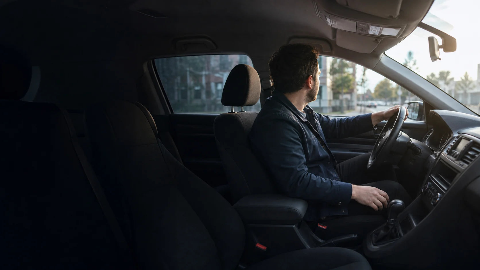Driver preparing for an everyday trip in a modern car