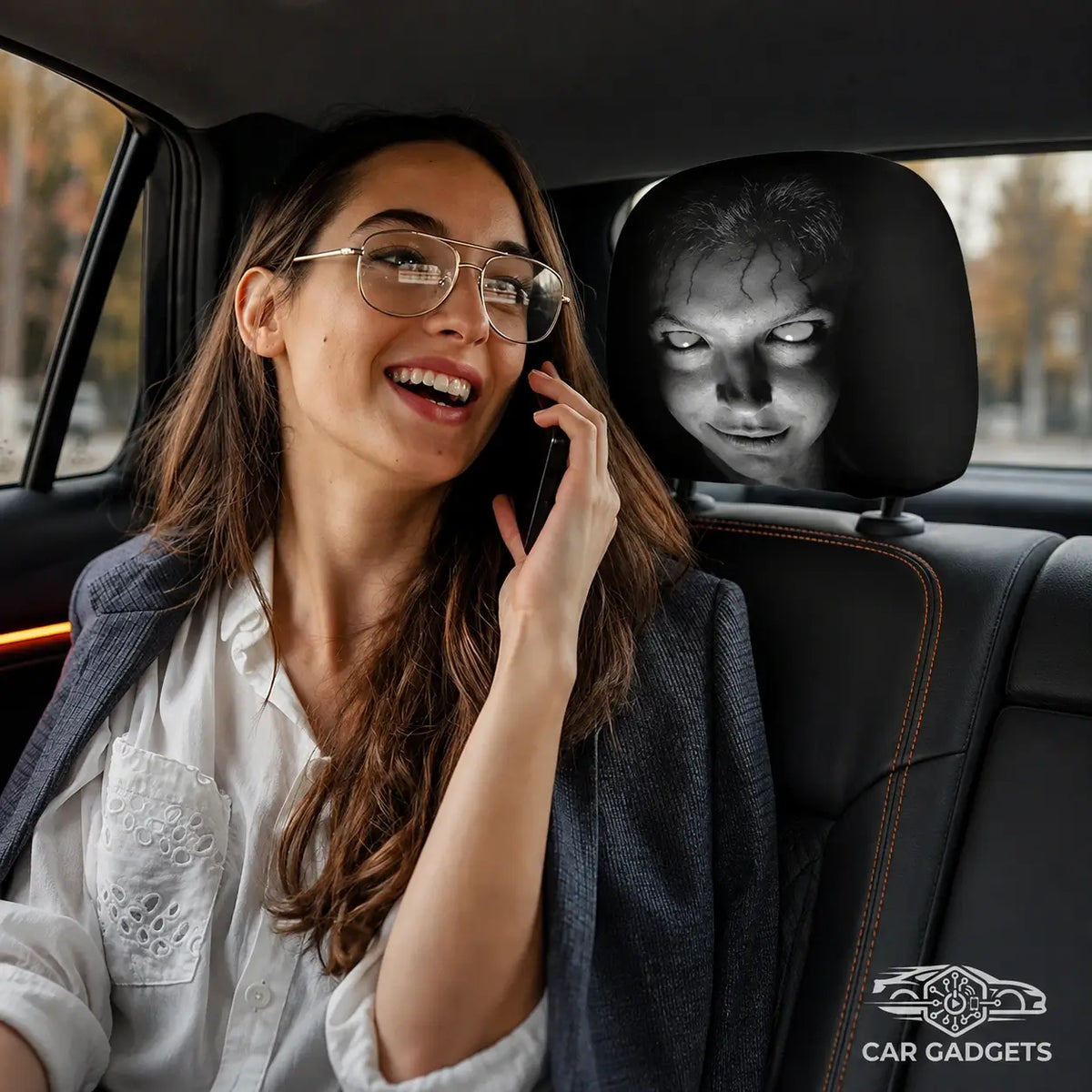 Passenger seated beside a car headrest fitted with a horror-face Halloween cover