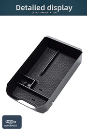 Detailed product view of the black Toyota RAV4 armrest organizer tray