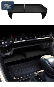 Black dividing shelf shown above the Toyota RAV4 front console storage area
