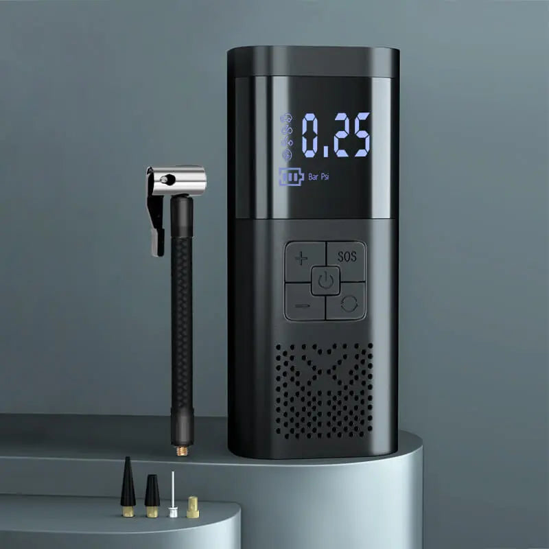 Cordless tire inflator with digital gauge showing 0.25 bar, inflatable tube nozzle, and valve adapters