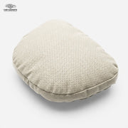 Beige perforated car neck pillow on a white background