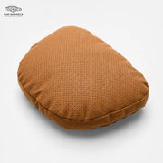 Cognac perforated car neck pillow on a white background