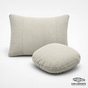 Beige car seat neck and lumbar pillow set on a white studio background