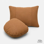 Cognac car seat neck and lumbar pillow set on a white studio background