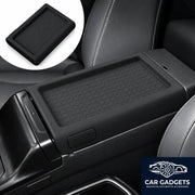 Black full-wrap silicone armrest cover installed on the center console of a 2026 Toyota RAV4