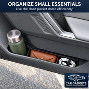 Door storage insert organizing a reusable bottle, small pouch and charging cable