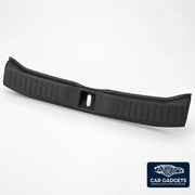 Close view of black TPE trunk sill guard ribs, curved edge and latch opening