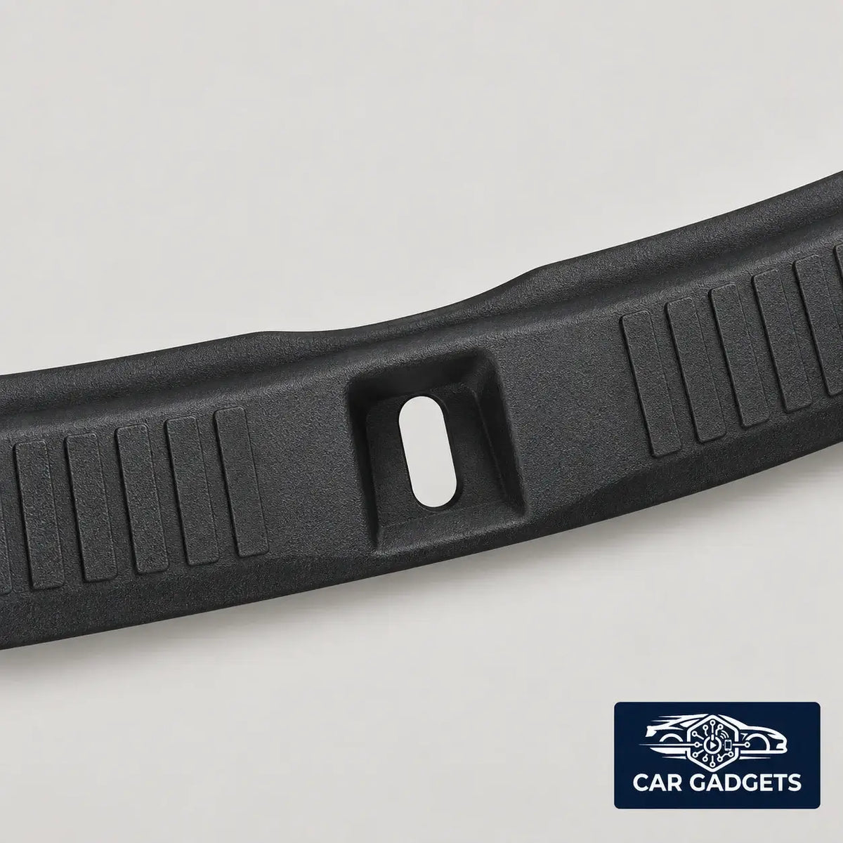 Close view of the inner trunk sill guard rib texture and center latch opening
