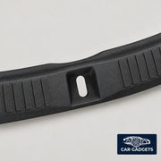 Close view of the inner trunk sill guard rib texture and center latch opening
