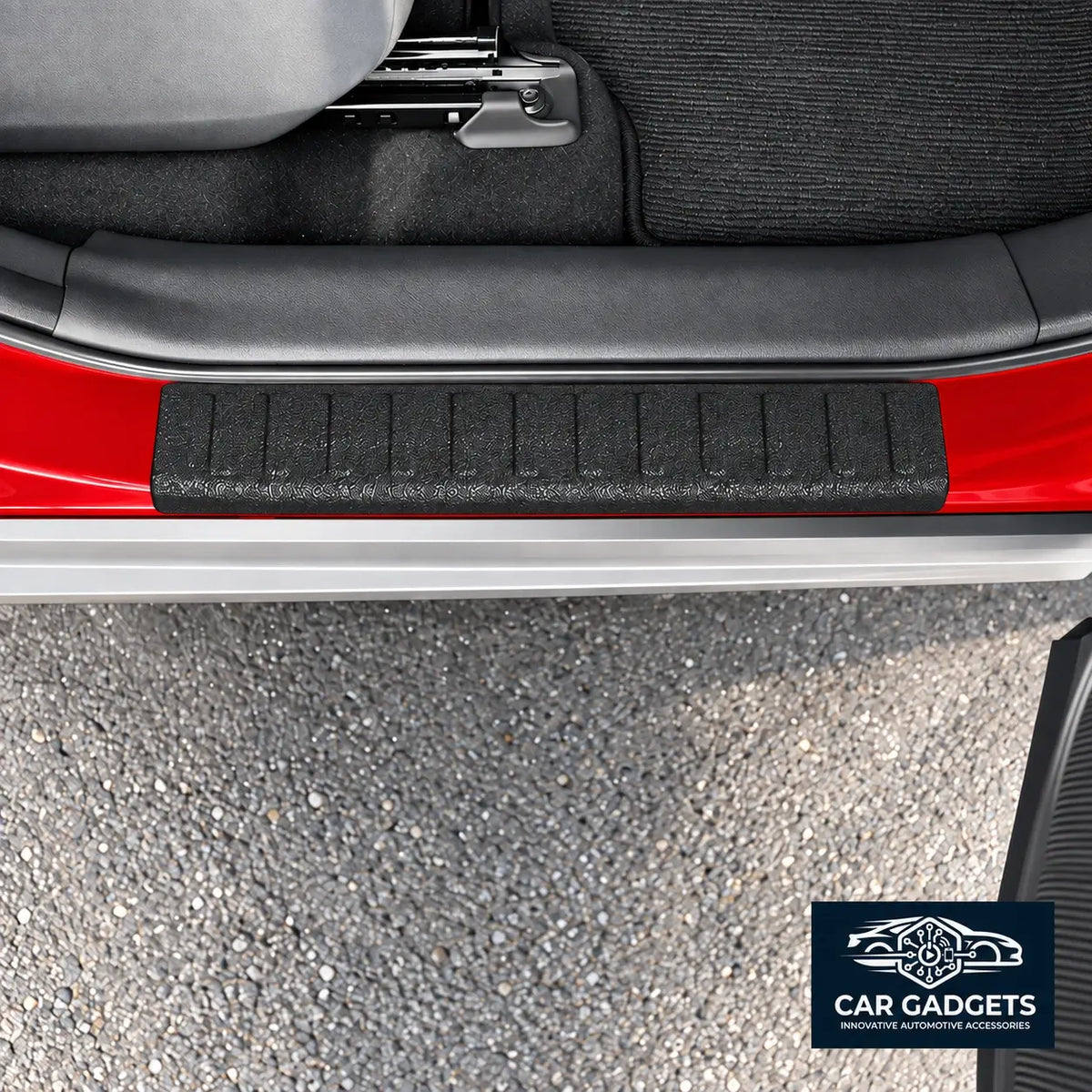 Black textured rear exterior bumper loading-edge protector shown installed on red vehicle