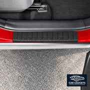 Black textured rear exterior bumper loading-edge protector shown installed on red vehicle