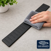 Black door sill protector being wiped clean with a cloth